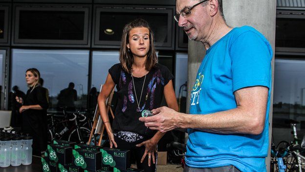 Emily Brooke showing the light to a man at a bike business event in London
