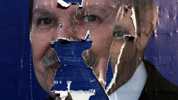 Torn election poster of Algerian President Abdelaziz Bouteflika