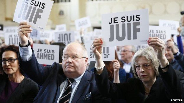 Eric Pickles and Theresa May hold up signs reading "I am Jewish"