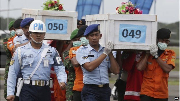 Members of the National Search and Rescue Agency carry coffins containing bodies of the victims aboard AirAsia Flight 8501 to transfer to Surabaya at the airport in Pangkalan Bun 19/01/2015