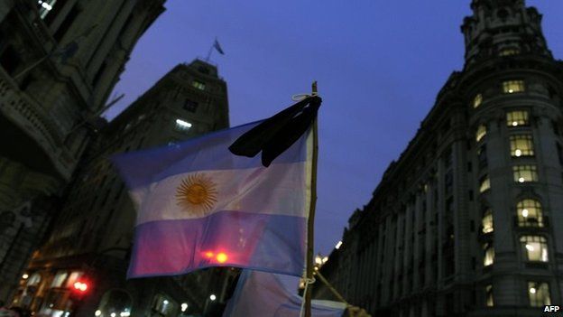 View of an Argentine flag with a black mourning crape during a demo at Plaza de Mayo in Buenos Aires on 19 January, 2015.