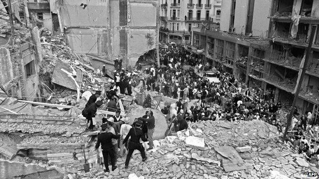 Firemen, policemen and rescuers search after a bomb exploded at the Argentine Israelite Mutual Association (Amia) in Buenos Aires on 18 July 1994,