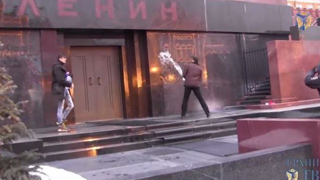 Screen grab from video shows men throwing water at mausoleum in Red Square, Moscow, said to be on 19 January 2015