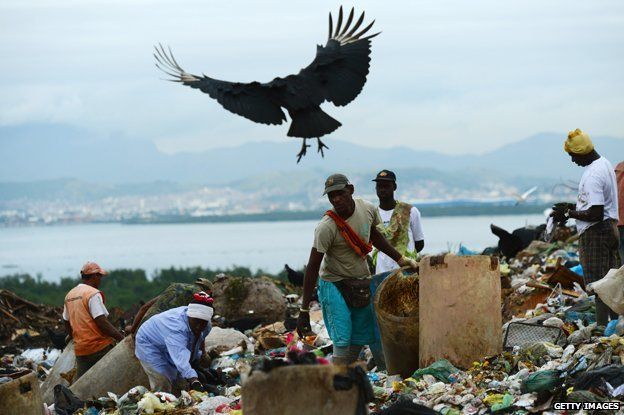 Pickers on the dump with a bird flying overhead