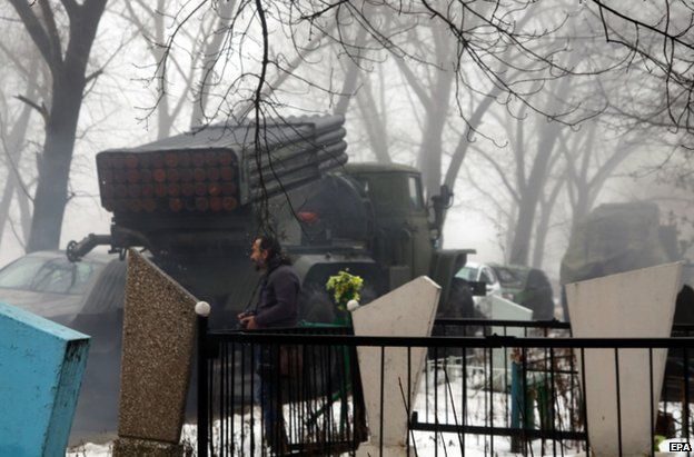 A rebel rocket launcher stands beside a cemetery in Donetsk, 20 January