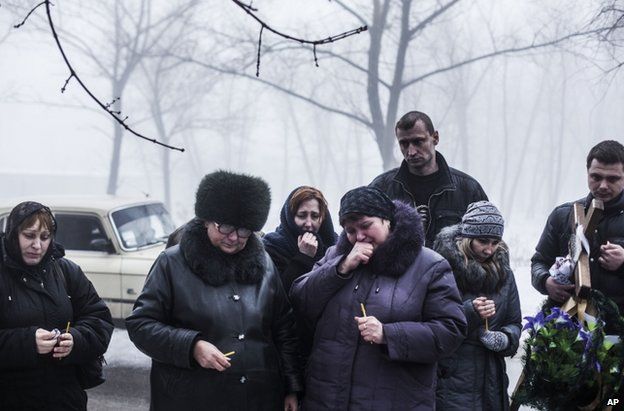 Mourners at the funeral of a four-year-old boy said to have been killed by Ukrainian army shelling in Donetsk city, 20 January