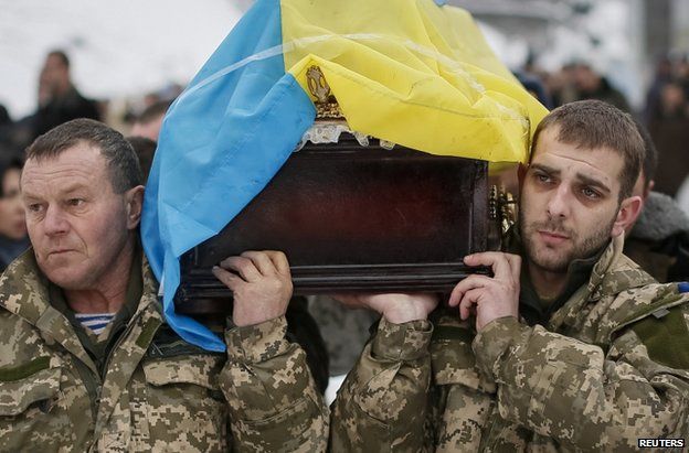 Ukrainian soldiers in Kiev carry the coffin of a comrade killed in Luhansk, 20 January