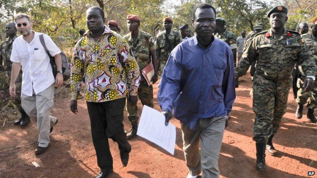 Dominic Ongwen (centre right) in the Central African Republic accompanied by Ugandan Contingent Commander to the African Union Regional Task Force Col Michael Kabango (right) Charge d'Affaires of the US Embassy in Bangui David Brown (left) and other unidentified military officials