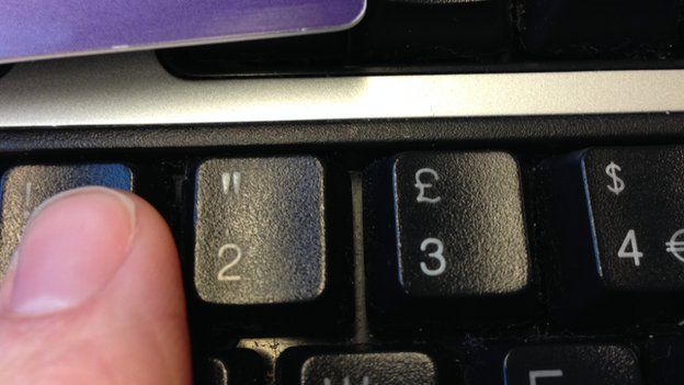 A person enters a password on a keyboard