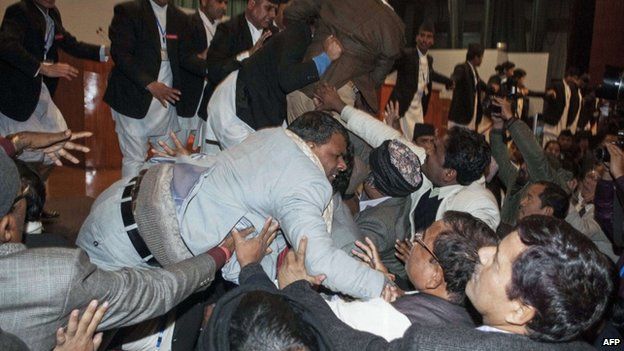 Nepalese constituent assembly members scuffle with security officers at parliament in Kathmandu early on January 20, 2015.