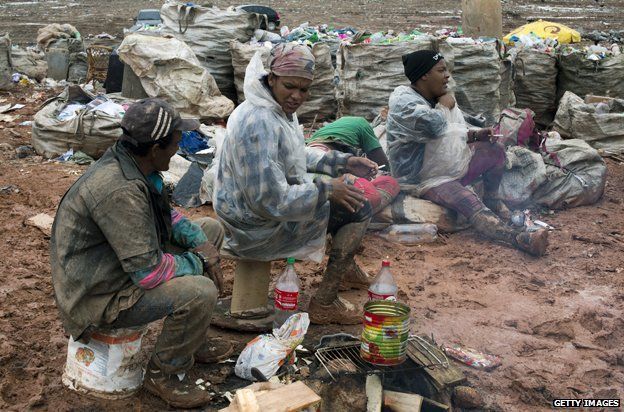 Pickers take a break among the rubbish