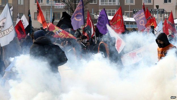 Protesters walk among tear gas smoke during a demonstration in front of the courthouse in Kayseri