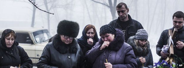 Mourners at the funeral of a child near Donetsk, 20 January