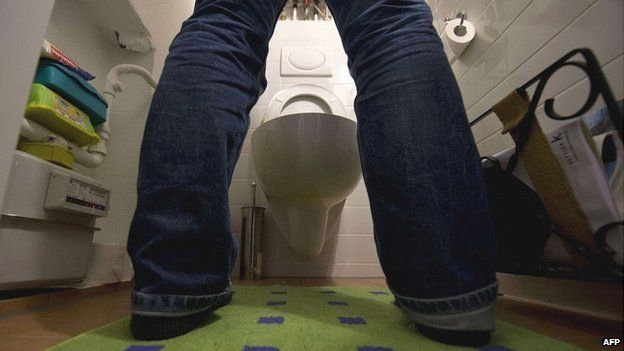 A man stands in front of a toilet in a Berlin flat - 22 January 2015