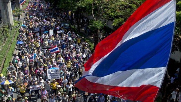 Thai anti-government protesters wave national flags during a rally in Bangkok on May 12, 2014.