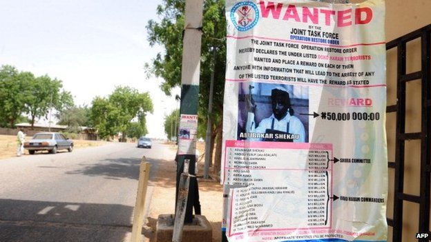 A poster displayed along the road shows photograph of Imam Abubakar Shekau, leader of the militant Islamist group Boko Haram, declared wanted by the Nigerian military - Maiduguri, Nigeria, 1 May 2013