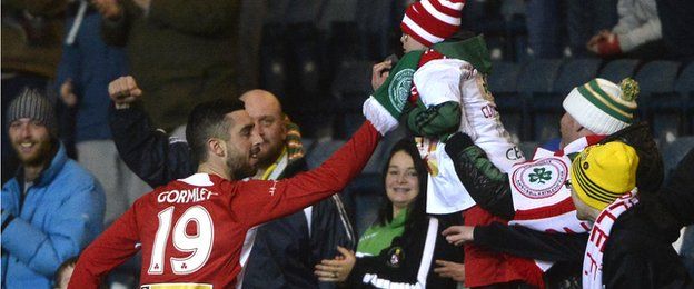 Joe Gormley celebrates scoring the opener with a young Cliftonville fan
