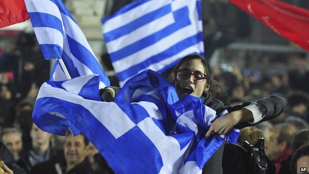 Crowd celebrates Syriza victory in Greece, waving flags