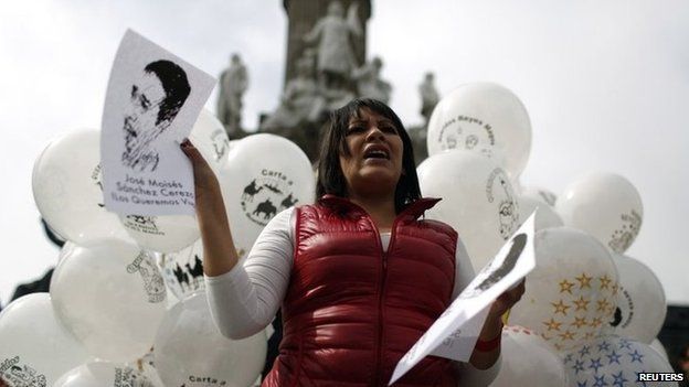 An activist holds a picture of missing journalist Moises Sanchez in Mexico City on 4 January, 2015.
