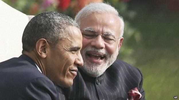 U.S. President Barack Obama, left and Indian Prime Minister Narendra Modi share a lighter moment over tea in the gardens of Hyderabad House where the leaders held their talks, in New Delhi, India, Sunday, Jan. 25, 2015.