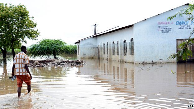 A church elder makes his way to his church through flood waters at Bangula, Malawi, in the southern district of Nsanje, Sunday Jan. 18, 2015.