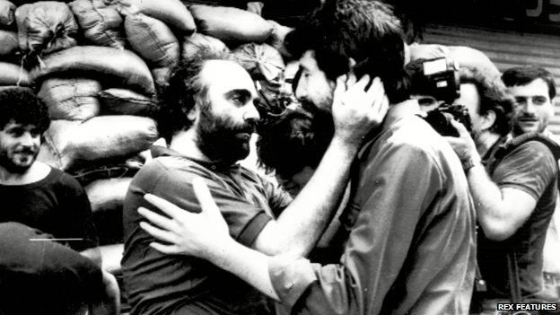 Demis Roussos embraces a militia commander after being released