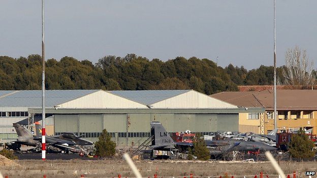 Fire engines work at Los Llanos air base in Albacete, eastern Spain (26 January 2015)
