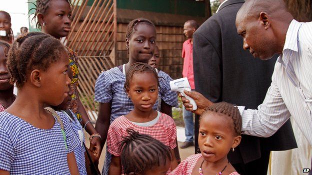 School children having their temperature tested in Guinea on 19 January 2015
