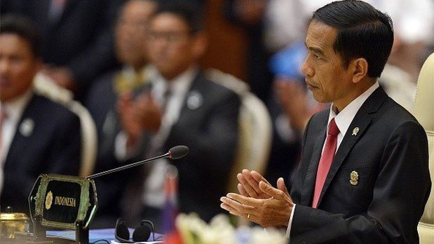 Indonesian President Joko Widodo applauds during the plenary session of the 25th ASEAN Summit at the Myanmar International Convention Center in Myanmar's capital Naypyidaw on November 12, 2014