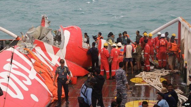 In this photograph taken on January 10, 2015, wreckage from AirAsia flight QZ8501 is lifted into a ship at sea south of Borneo island.