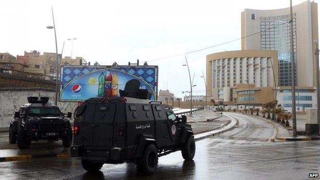 Libyan security forces and emergency services surround Tripoli's central Corinthia Hotel (right), 27 January 2015