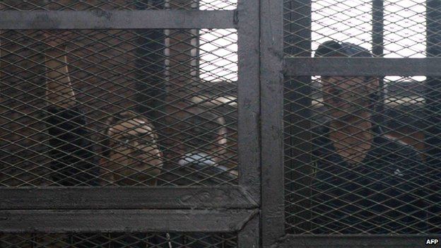 Egyptian prominent activists Ahmed Douma (R) and Ahmed Maher (L)react as they stand in the dock during their failed appeal on 7 April 2014