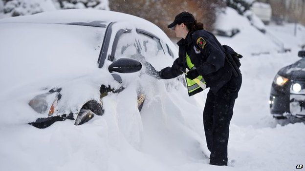 Police officer Heather Buonanni tickets an illegally parked car along McKinley Avenue in Norwich, Connecticut on 27 January 2015