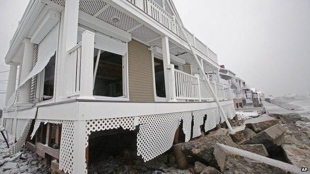 A damaged house sits along the coast in the Brant Rock section of Marshfield in the US during a winter snowstorm