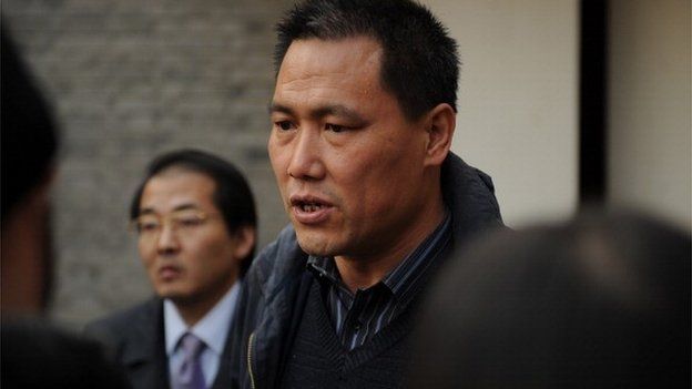 Pu Zhiqiang (C), the lawyer for Chinese artist Ai Weiwei, talks to the media at the artist's studio in Beijing on November 14, 2011.