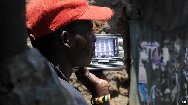A Kenyan man listens to news on a radio on 5 March 2013 in Nairobi's sprawling Kibera slum