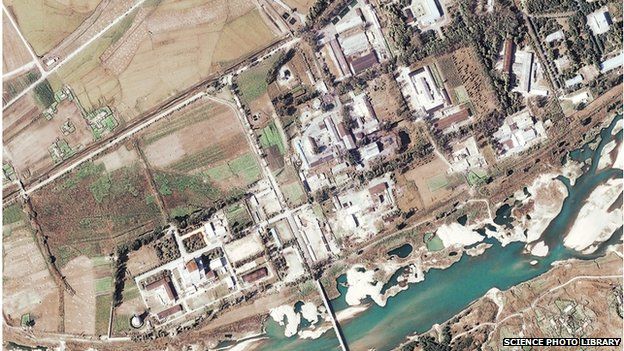 Nuclear reactor, North Korea. Satellite image of a five-megawatt nuclear reactor (centre left) in Yongbyon in North Korea. The steam coming from the white tower (lower left) indicates the reactor is in operation, since being restarted in early 2003. Photographed on 7 November 2004 by the Quickbird satellite.
