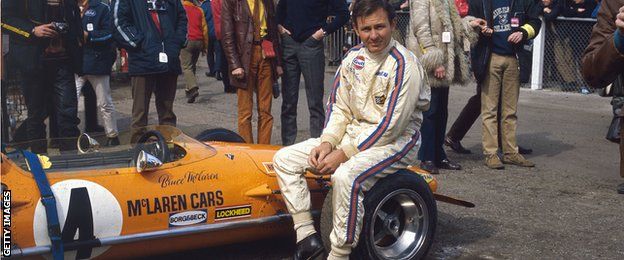Bruce McLaren sits on a wheel of the M14A in 1970