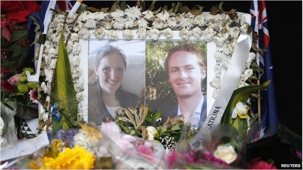 Photographs of Katrina Dawson and Tori Johnson are displayed in a floral tribute near the site of the siege in Sydney's Martin Place, 23 December 2014.