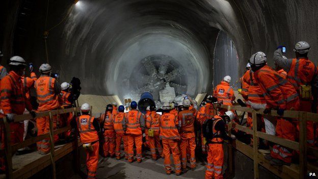 Workmen look on as tunnel machine, named Elizabeth, breaks through into the east end of Crossrail"s Liverpool Street station