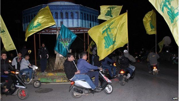 Lebanese Hezbollah supporters celebrate the attack in the village of Kfar Kila in southern Lebanon on 28 January.