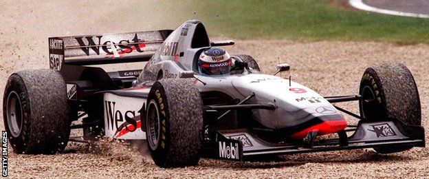Mika Hakkinen drives through a gravel trap at the