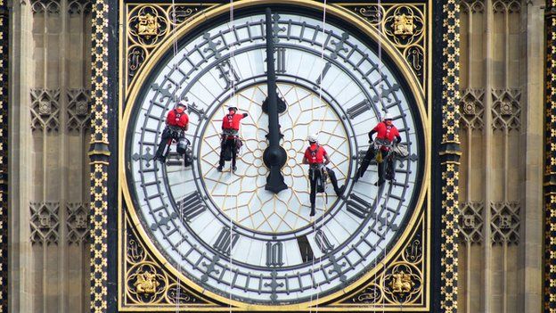 Abseilers clean and inspect the famous Westminster clock face