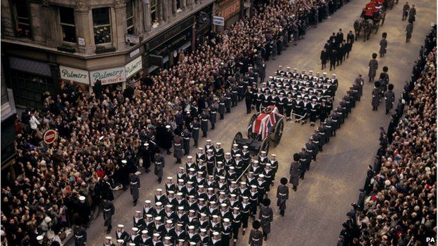 Crowds lining a London street as the coffin of Sir Winston Churchill passes along