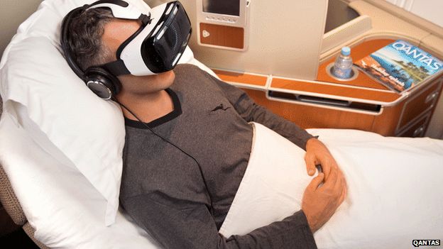 Man on plane wearing Samsung Gear virtual reality headset