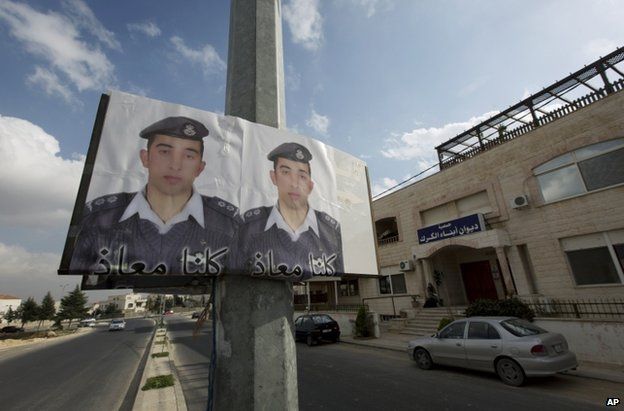 Posters with pictures of Jordanian pilot Lt Moaz al-Kasasbeh on a pole in Amman, 29 January