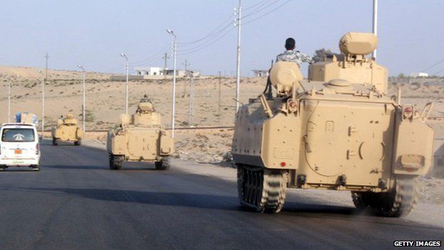 Egyptian armoured vehicles head along a road in El-Arish on way to the Rafah. 13 August 2011
