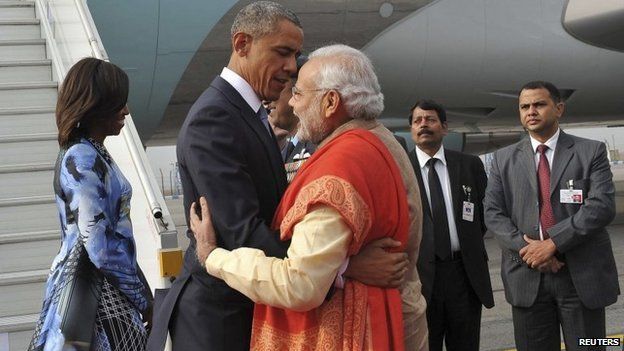 India's Prime Minister Narendra Modi (C) hugs US President Barack Obama at Air Force Station Palam in New Delhi on 25 January 2015