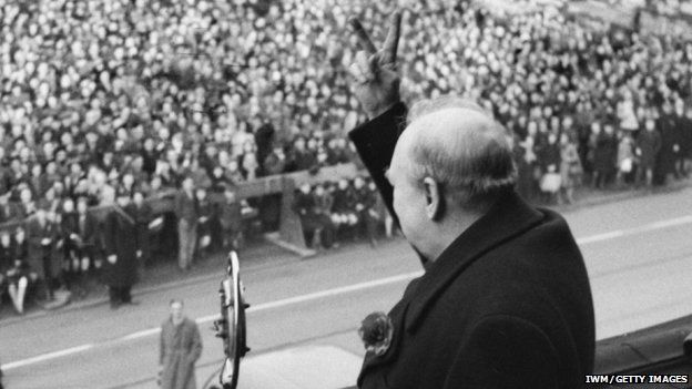 Sir Winston Churchill displays a v sign to crowd