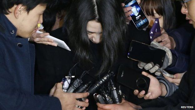 Cho Hyun-ah bows her head as she is led into detention on 30 December 2014